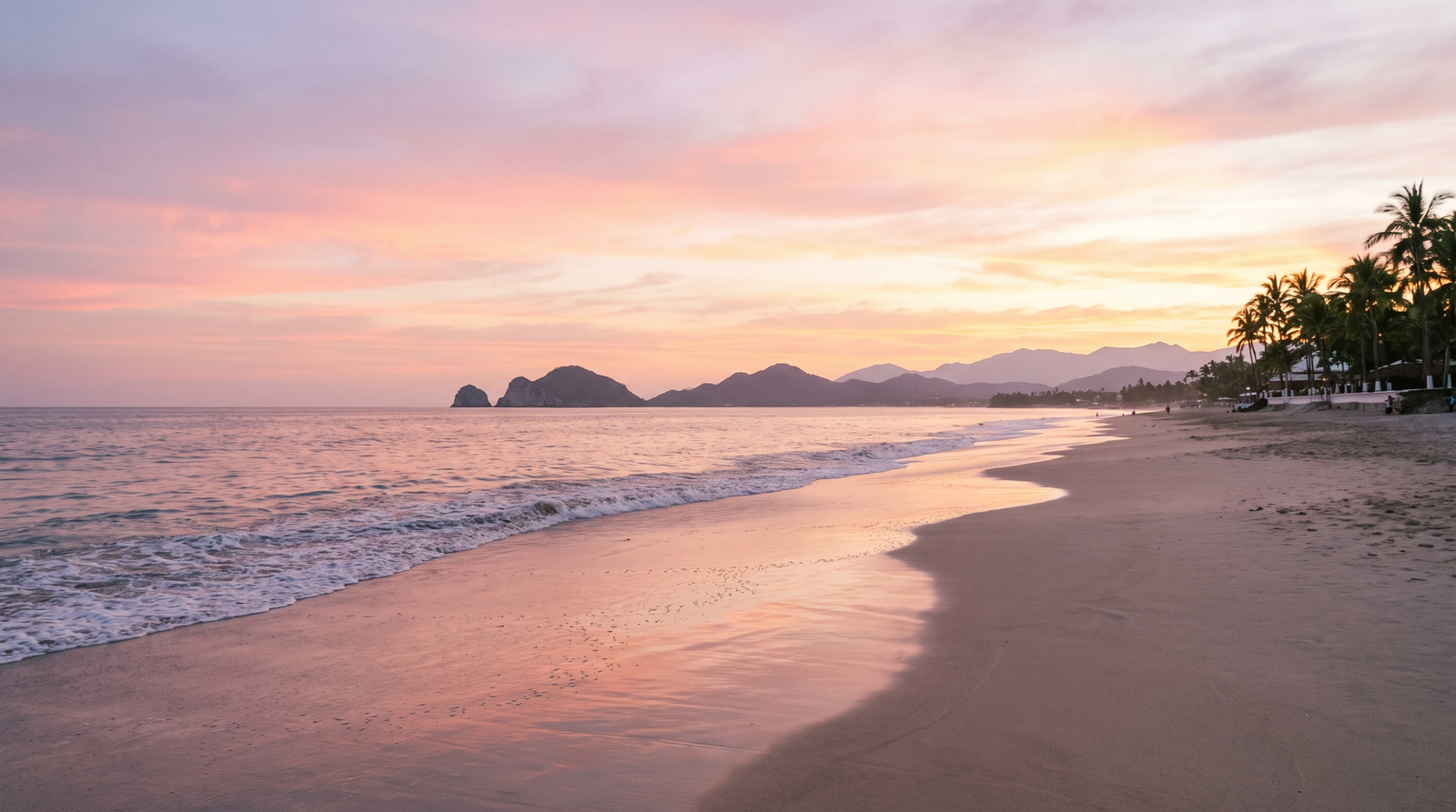 Wide sandy beach in Puerto Vallarta with palapas and calm bay water
